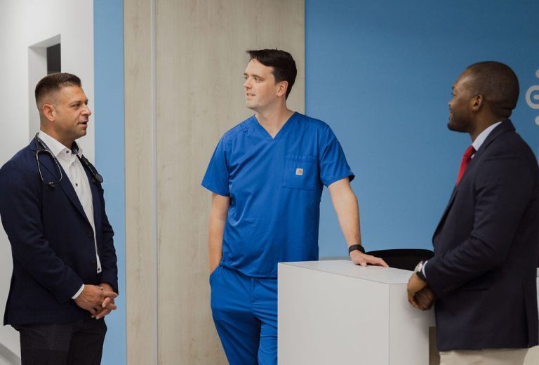 Three doctors talking to each other